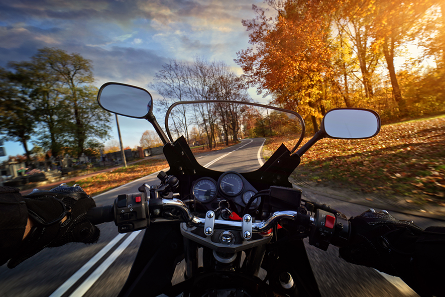 Driving a motorbike on an autumn sunny day