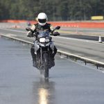 biker on road with helmet and wet asphalt